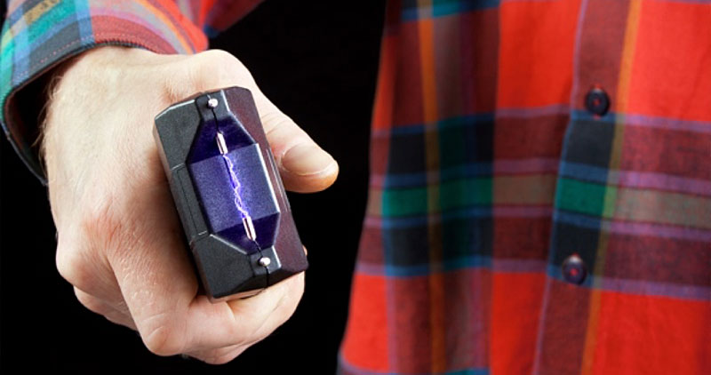 Male hand holding a powered tazer
