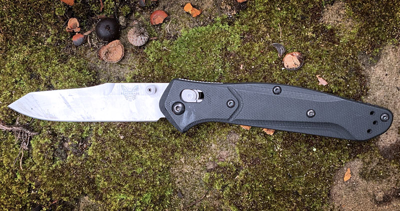 Benchmade 940-2 Osborne AXIS Lock Knife open on some moss
