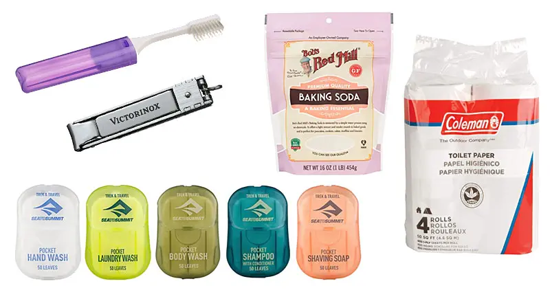 A toothbrush, nail clipper, baking soda, camping toilet paper and camping soaps