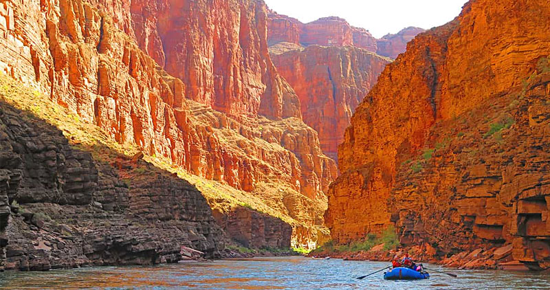Use a signal mirror in grand canyon: picture of people on a raft in the river