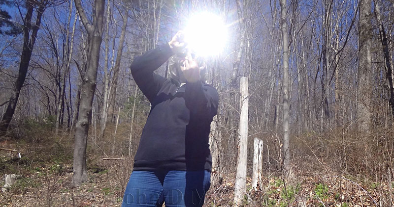 Using a signal mirror in the woods