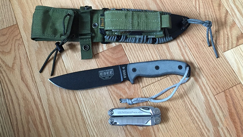ESEE 6P knife next to a sheath and a Leatherman multitool on the floor