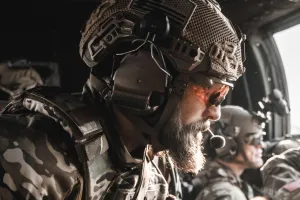 Man in a helicopter wearing a helmet