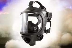 MIRA Safety CM-6M Tactical Gas Mask in a cloud of white and purple smoke