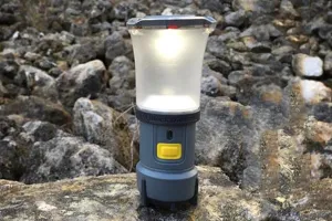 Grey Black Diamond Voyager Lantern sitting on some rocks