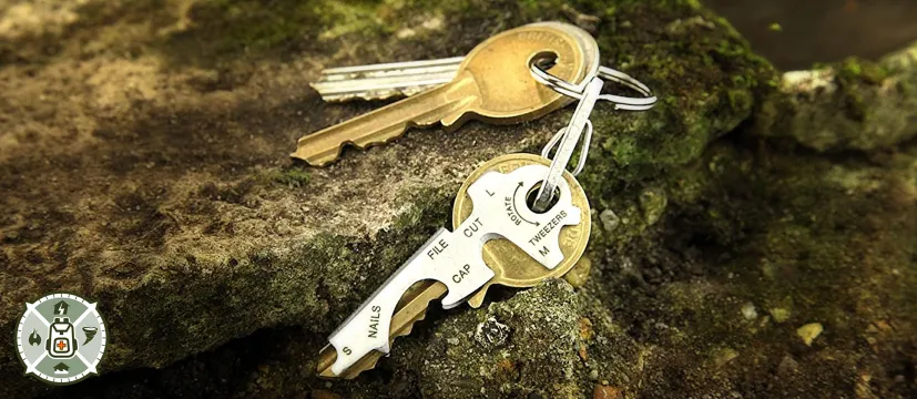 True Utility KeyTool Multitool on a key ring sitting on some rocks